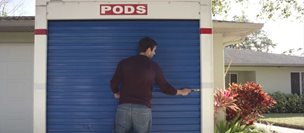 Man locking 8 foot PODS container