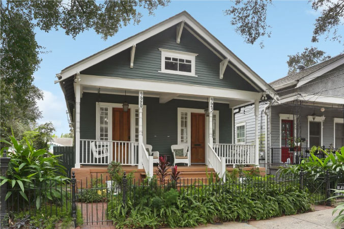 A green duplex that’s been transformed into a single-family home in the Irish Channel neighborhood of New Orleans, Louisiana.