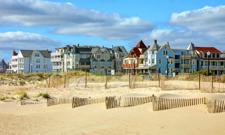 A scenic view of oceanfront homes and condos in Ocean Grove, New Jersey, as seen from the sandy beach.