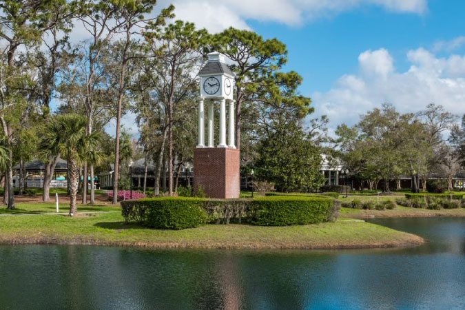 A waterside clock tower in Lake Mary — one of the best Orlando suburbs