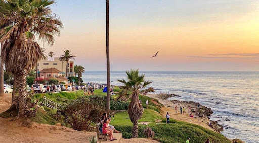 Locals are enjoying the sunset at a beach in San Diego’s La Jolla. 
