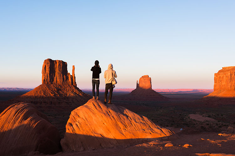 Two hikers take photos of the desert buttes outside of Phoenix