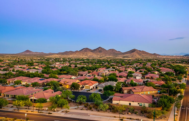 Anthem homes sit in the foreground in twilight with the mountains looming in the background