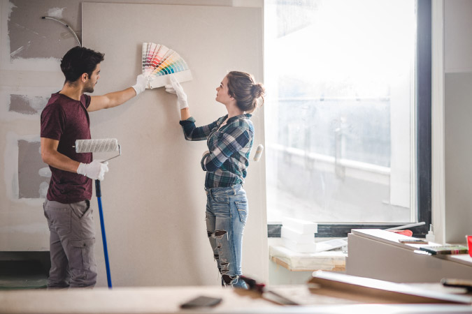 A couple is looking at paint swatches together during their kitchen remodel