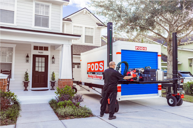 A PODS driver uses PODZILLA to carefully place a PODS container in a customer’s driveway while keeping it level.