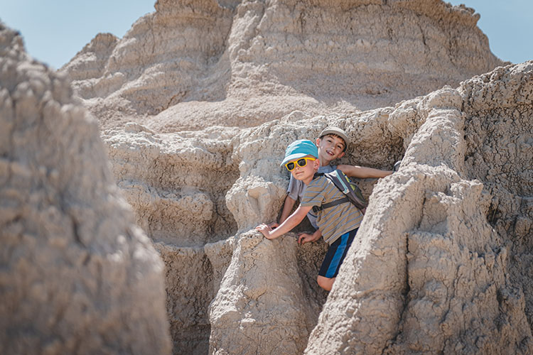 Two young boys climbing the rocks in South Dakota's Badlands