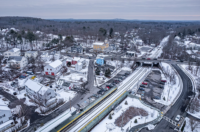 A bird's eye view of the Boston suburb of Acton. the town is covered in snow. 