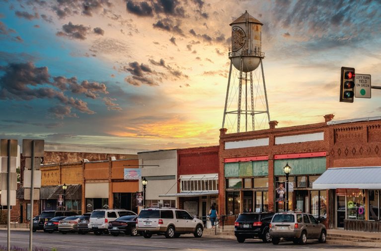 Storefronts and a water tower in Blanchard, Oklahoma, one of the many cities near Oklahoma City