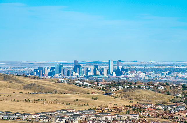 Denver’s downtown stands in the background, with a Denver suburb in the foreground.