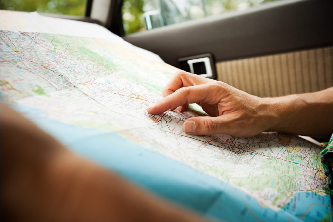 Close-up of a soldier’s hands on a map of the United States, as he points to where he will be moving for his upcoming PCS.