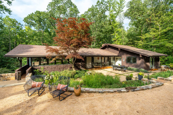 A mid-century home with terraced landscaping and a forested back yard in Durham’s Duke Forest neighborhood.
