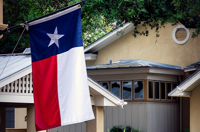 A San Antonio home with the Texas Lone Star flag flying in front