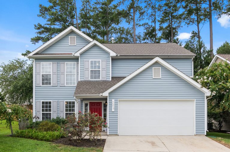 blue house with large garage door