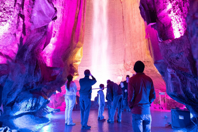 A group of people marvel at the underground waterfall at Lookout Mountain’s Ruby Falls near Chattanooga, TN.