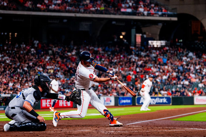 An action shot of a batter taken just after he hit a ball during a Houston Astros game.