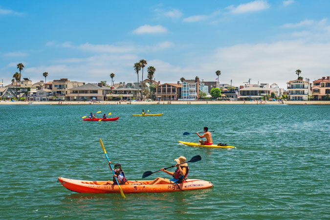 Locals kayak off the beach in Long Beach, California, on a sunny day.