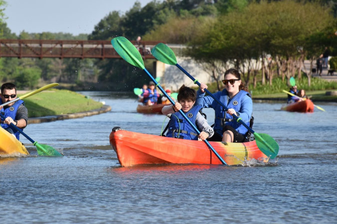Locals enjoy a sunny day kayaking in The Woodlands, Texas. 