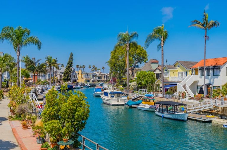 The Naples Beach neighborhood in Long Beach, California, featuring a beautiful canal lined with private docks and large, single-family homes.