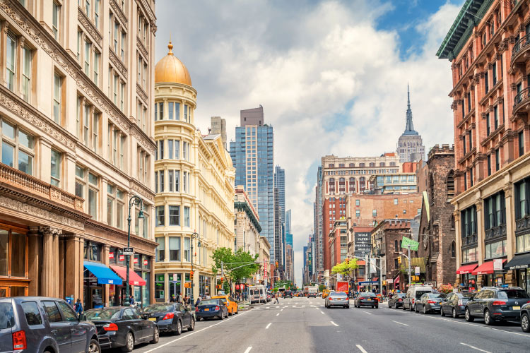 A view down 6th Avenue in the Chelsea neighborhoods of Manhattan on a sunny day. 