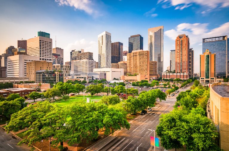 One of the many pros of living in Houston, Texas, is the impressive city skyline, as seen in this image.