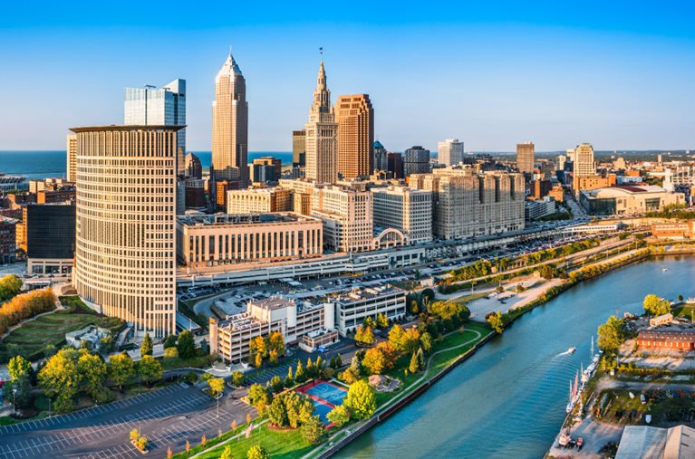 Aerial view of Downtown Cleveland, Ohio, and the Cuyahoga River on a sunny day.