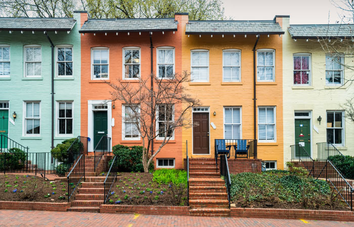 A row of colorful brick row houses in the Georgetown neighborhood of Washington, D.C.
