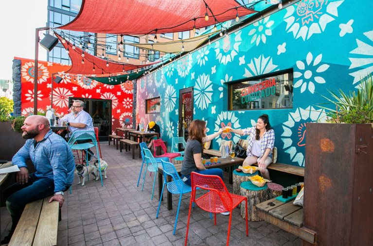 Locals enjoy a refreshing local craft beer and al fresco food at Cerveceria Colorado in Denver, Colorado.