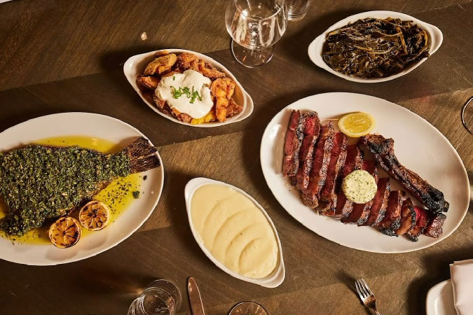 A tasty spread from The Grey restaurant in Savannah, Georgia, featuring expertly prepared fish, meat, and vegetables.