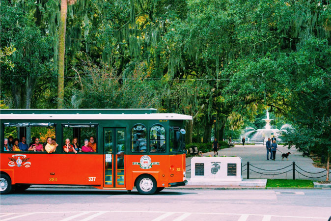 A group of people are riding the Old Town Trolley in Savannah during a tour of the historic city.