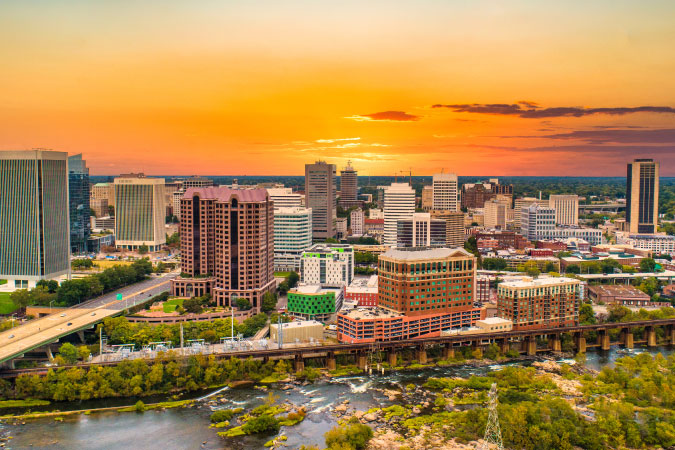 Aerial view of Richmond, Virginia, during sunset, featuring the river in the foreground.