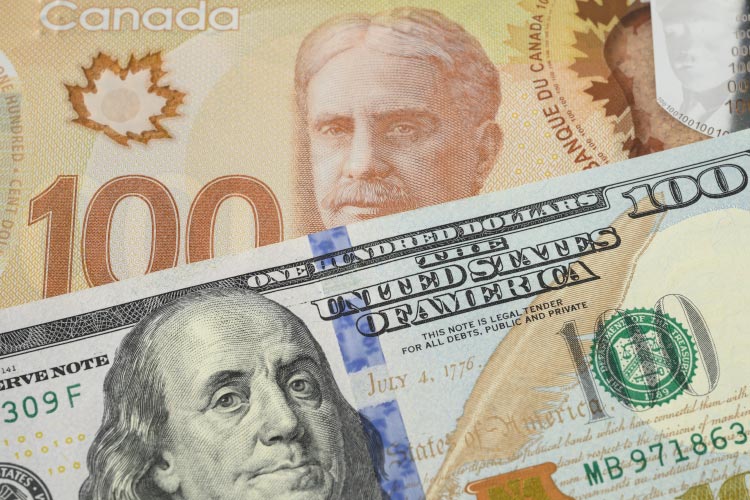 A close-up image of both the Canadian and American hundred dollar bills.