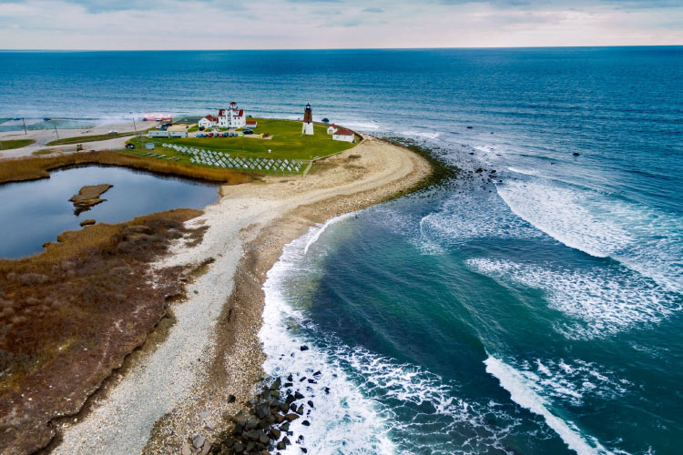 Aerial view of Point Judith Lighthouse in Narragansett, Rhode Island, and the surrounding ocean.