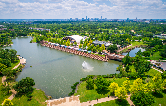 Aerial view of Mueller Pond in the Austin suburbs with a view of the city skyline in the distance.