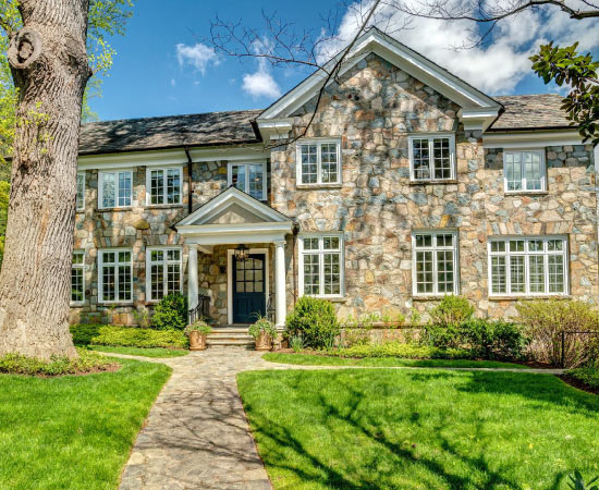 A large home in D.C.’s Wesley Heights neighborhood, featuring a stone facade and pillared entrance.