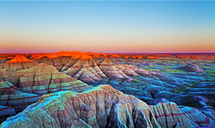 Aerial view of sunset over The Wall rock formation in Badlands National Park near Wall, South Dakota.