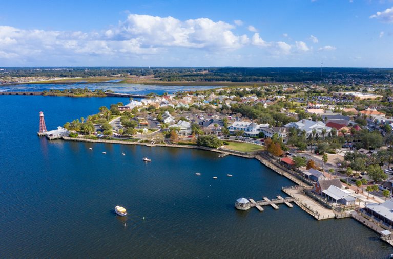 Aerial view of one of The Villages neighborhoods, featuring the waterfront and a lighthouse.