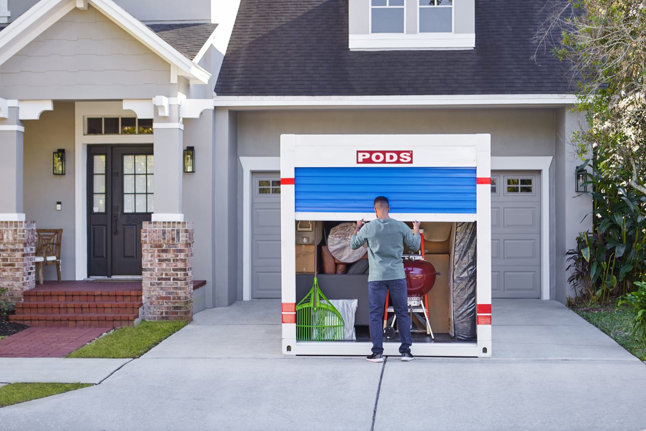 Man closing PODS container in driveway