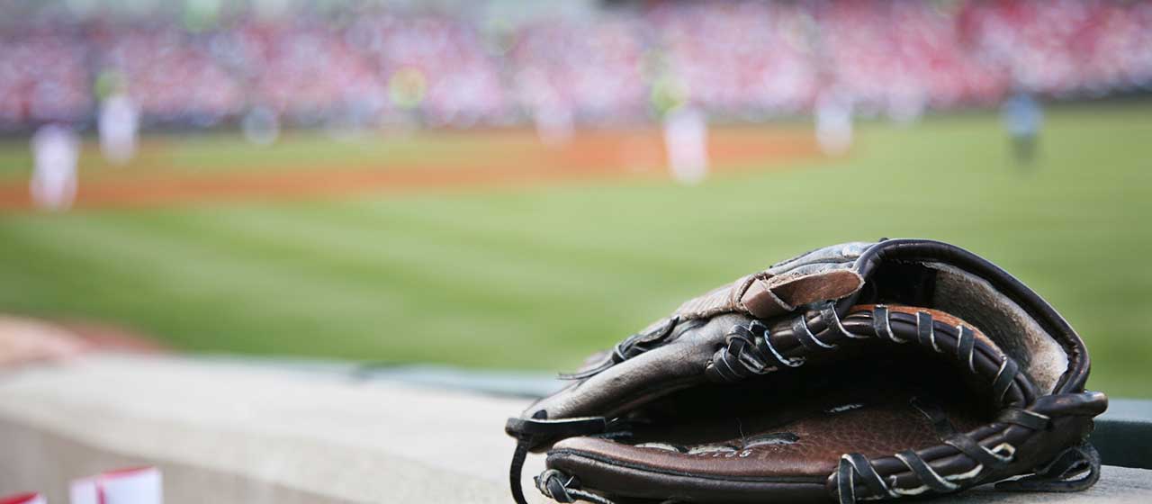 A baseball glove overlooking a sports stadium