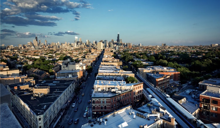 Aerial view of the Wicker Park neighborhood in Chicago, featuring the city skyline in the distance