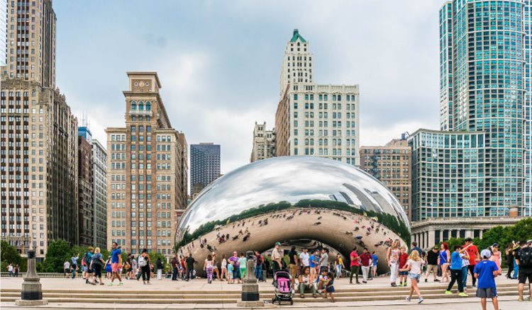 It’s a beautiful overcast day in Chicago’s downtown Loop neighborhood, where dozens of people are visiting the Bean sculpture in Millenium Park.