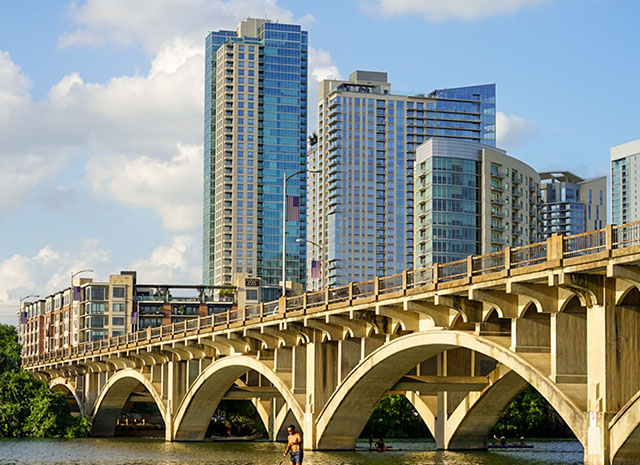 The Lamar Boulevard Bridge in Austin, Texas with skyscrapers sitting behind it