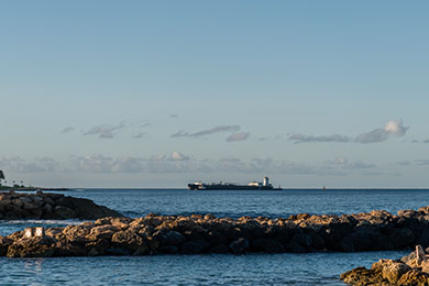 A ship carrying containers arriving in Hawaii