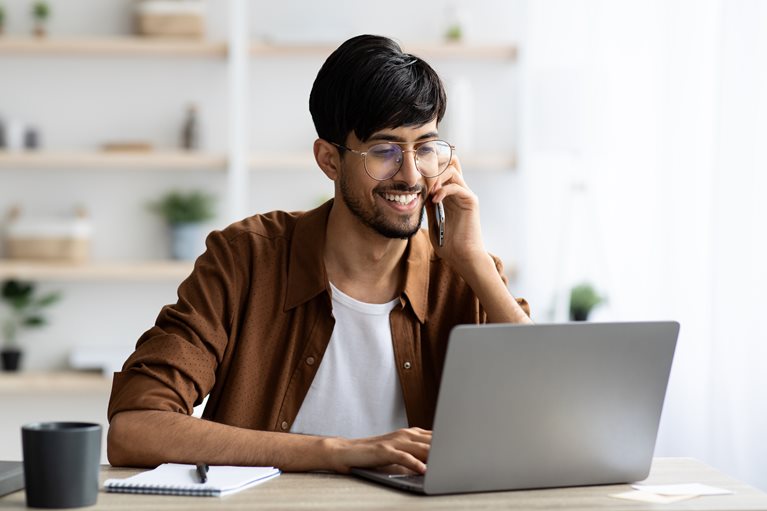 Man on a phone and computer