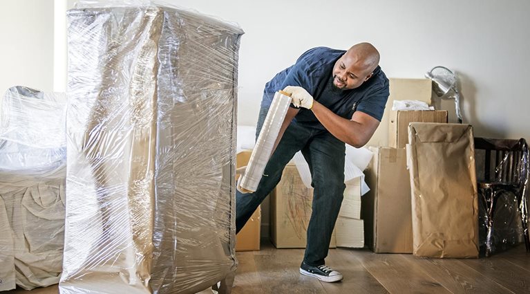 Professional mover moving dresser