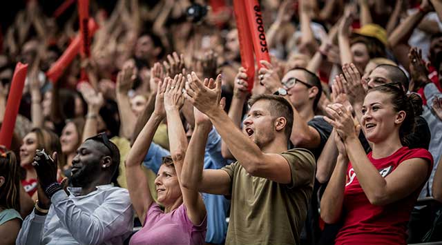 A crowd cheering on a sports team