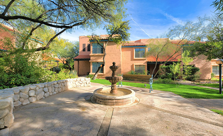 A small water fountain and wooden bench in the Poets Square neighborhood of Tucson