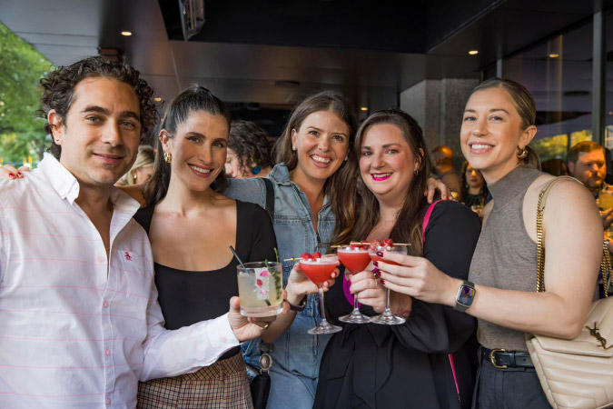 Friends pose for a picture with their fancy cocktails during a night out at the Atlanta Food & Wine Festival