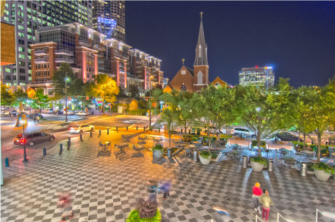 Nighttime view of the buildings and architecture surrounding the Mint Museum in Charlotte, North Carolina