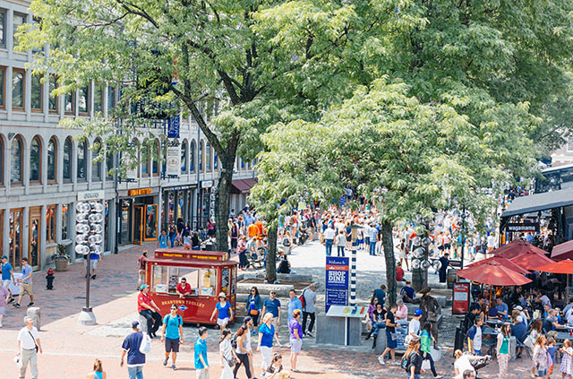 Families promenade around Faneuil Hall Marketplace in Boston, Massachusetts.