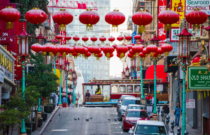  A street in San Francisco’s Chinatown has red paper lanterns strung across buildings above the roadway.